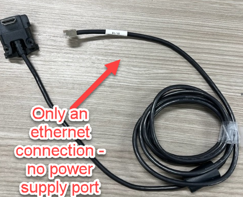 A black cable with a red arrow pointing to it

Description automatically generated